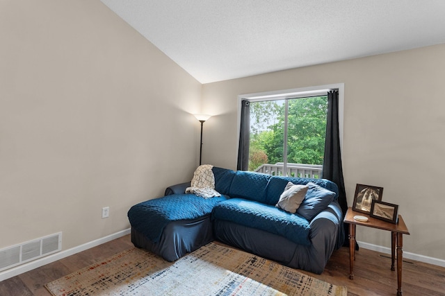 903 3rd Ave SW, Isanti, MN 55040 - living area with wood finished floors, baseboards, and vaulted ceiling