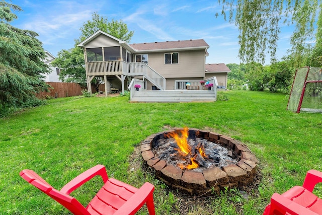 903 3rd Ave SW, Isanti, MN 55040 - back of house with a fire pit, a sunroom, and stairway