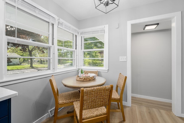 1805 Melrose Ave, Saint Louis Park, MN 55426 - dining space featuring light wood-type flooring, baseboards, and a chandelier