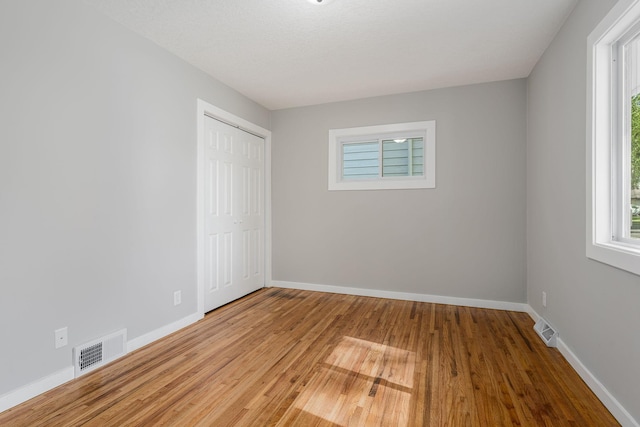 1805 Melrose Ave, Saint Louis Park, MN 55426 - empty room with healthy amount of natural light, wood finished floors, and baseboards