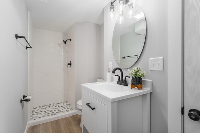 1805 Melrose Ave, Saint Louis Park, MN 55426 - bathroom with tiled shower, vanity, toilet, and wood finished floors