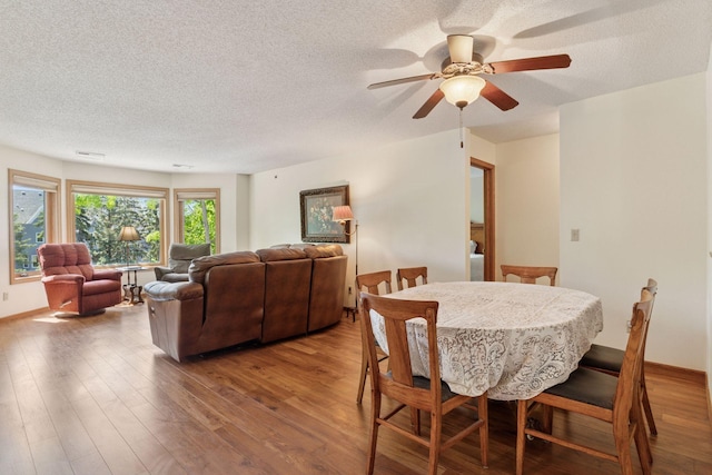 32 11th Ave S Unit 204, Hopkins, MN 55343 - dining room with a textured ceiling, wood finished floors, and a ceiling fan