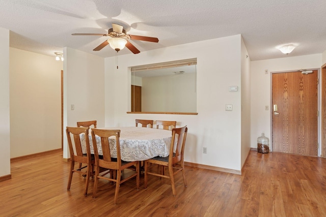 32 11th Ave S Unit 204, Hopkins, MN 55343 - dining area featuring wood finished floors, ceiling fan, baseboards, and a textured ceiling