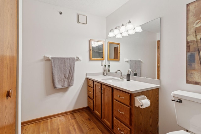 32 11th Ave S Unit 204, Hopkins, MN 55343 - bathroom featuring toilet, wood finished floors, vanity, and baseboards