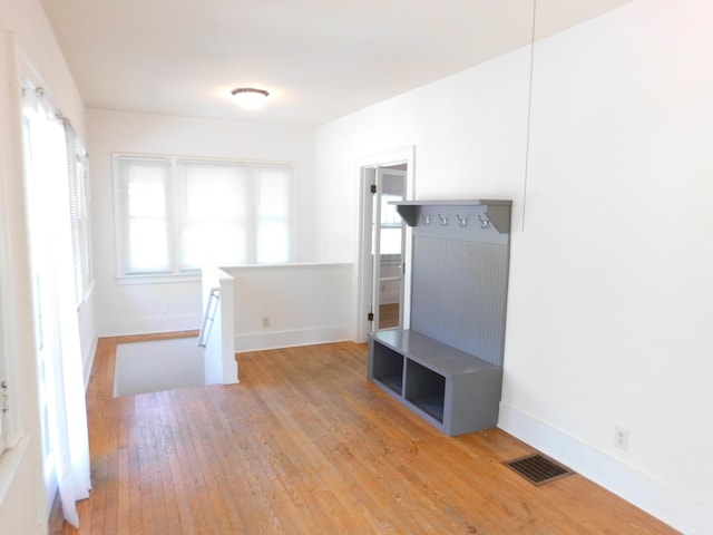 unfurnished room with hardwood / wood-style flooring and baseboards