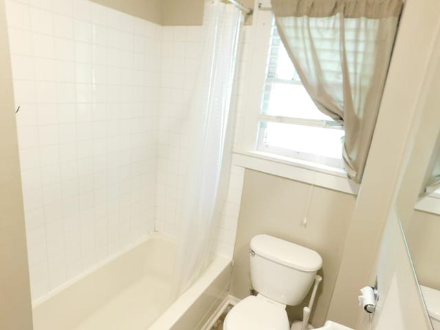 bathroom with toilet and shower / bath combo