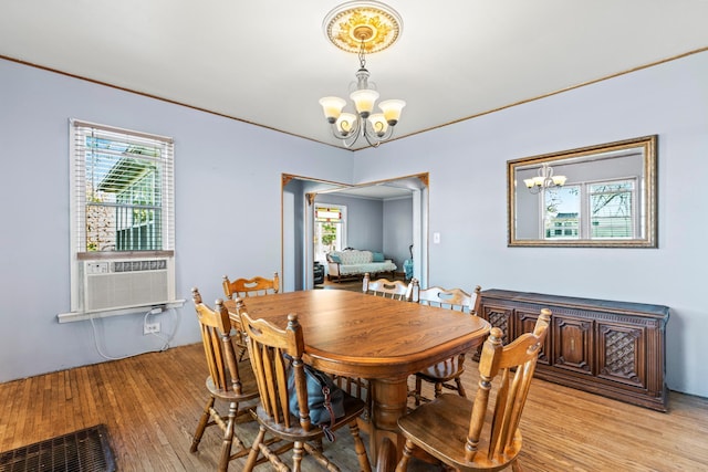 37726 2nd Ave, Dennison, MN 55018 - dining space featuring a chandelier, light wood-style floors, plenty of natural light, and cooling unit