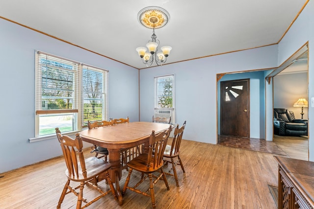 37726 2nd Ave, Dennison, MN 55018 - dining space featuring a chandelier, light wood finished floors, plenty of natural light, and crown molding