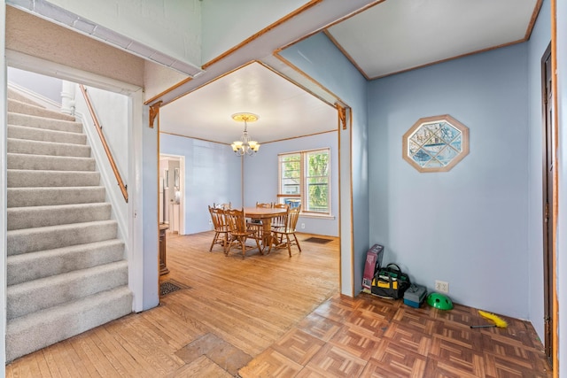 37726 2nd Ave, Dennison, MN 55018 - dining space featuring stairs, a chandelier, and parquet flooring