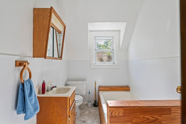 37726 2nd Ave, Dennison, MN 55018 - bathroom with tile walls, toilet, a garden tub, and vanity