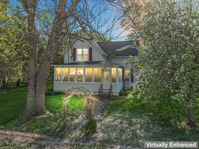 37726 2nd Ave, Dennison, MN 55018 - rear view of house featuring a sunroom, a lawn, entry steps, and roof with shingles