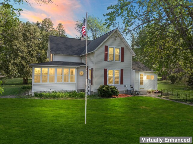 37726 2nd Ave, Dennison, MN 55018 - back of house at dusk featuring a sunroom and entry steps