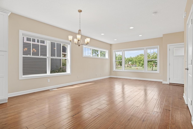 5024 Humboldt Ln N, Minneapolis, MN 55430 - empty room featuring a chandelier, wood finished floors, baseboards, and recessed lighting