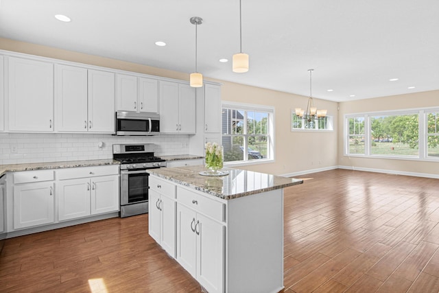 5024 Humboldt Ln N, Minneapolis, MN 55430 - kitchen with stainless steel appliances, wood finished floors, backsplash, healthy amount of natural light, and recessed lighting