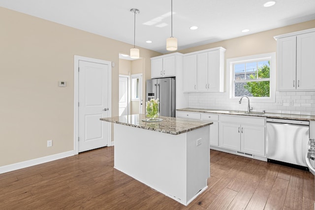 5024 Humboldt Ln N, Minneapolis, MN 55430 - kitchen with appliances with stainless steel finishes, a sink, decorative backsplash, dark wood-style floors, and light stone countertops