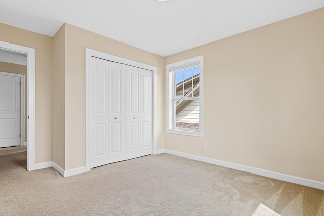5024 Humboldt Ln N, Minneapolis, MN 55430 - unfurnished bedroom featuring light colored carpet, baseboards, and a closet