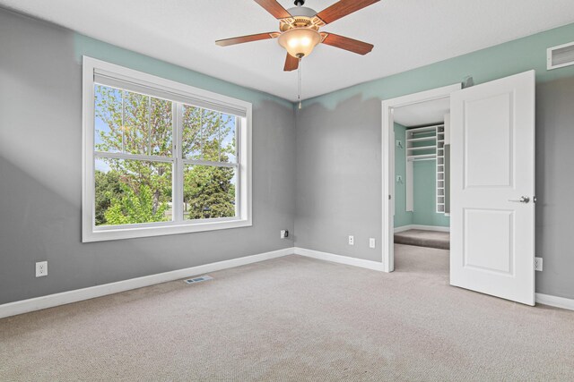 5024 Humboldt Ln N, Minneapolis, MN 55430 - unfurnished bedroom with carpet, baseboards, a walk in closet, a closet, and ceiling fan