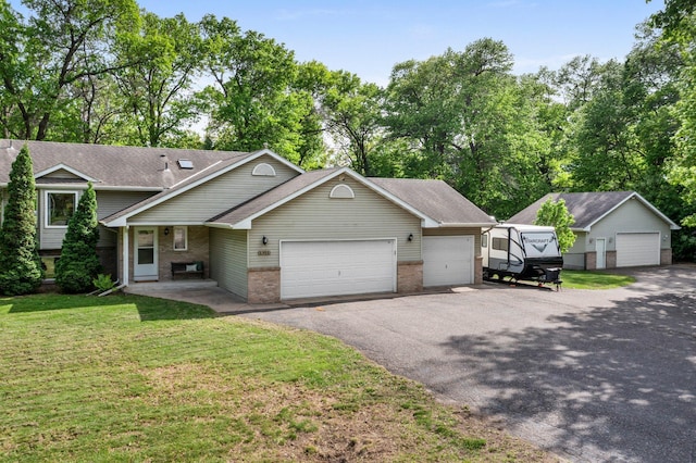 2308 Crosstown Blvd NE, Ham Lake, MN 55304 - view of front of house with brick siding, a front lawn, a garage, a shingled roof, and driveway