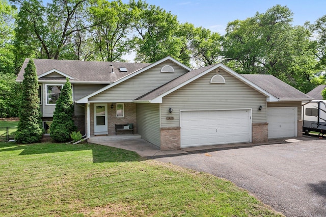 2308 Crosstown Blvd NE, Ham Lake, MN 55304 - tri-level home featuring brick siding, a garage, asphalt driveway, a front yard, and a shingled roof
