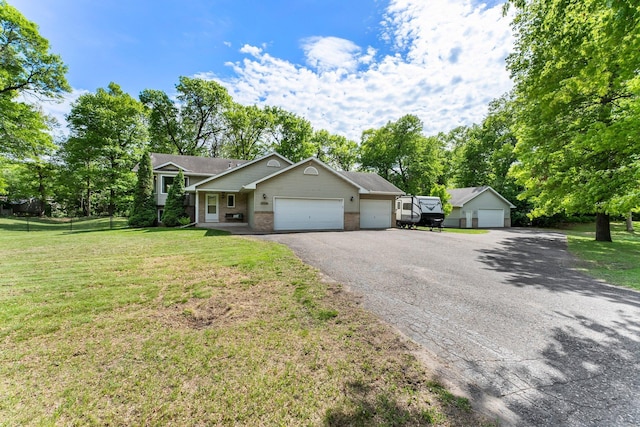 2308 Crosstown Blvd NE, Ham Lake, MN 55304 - view of front of home with brick siding, an attached garage, a front lawn, and view of scattered trees