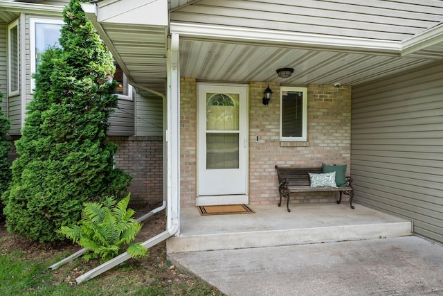 2308 Crosstown Blvd NE, Ham Lake, MN 55304 - view of exterior entry featuring covered porch and brick siding