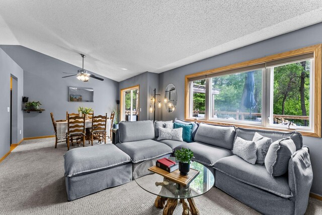 2308 Crosstown Blvd NE, Ham Lake, MN 55304 - living room with vaulted ceiling, carpet, a textured ceiling, baseboards, and a ceiling fan