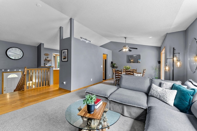 2308 Crosstown Blvd NE, Ham Lake, MN 55304 - living area featuring vaulted ceiling, carpet floors, ceiling fan, and a textured ceiling