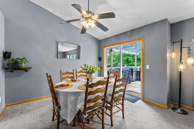 2308 Crosstown Blvd NE, Ham Lake, MN 55304 - dining room with carpet flooring, lofted ceiling, a ceiling fan, baseboards, and a textured ceiling