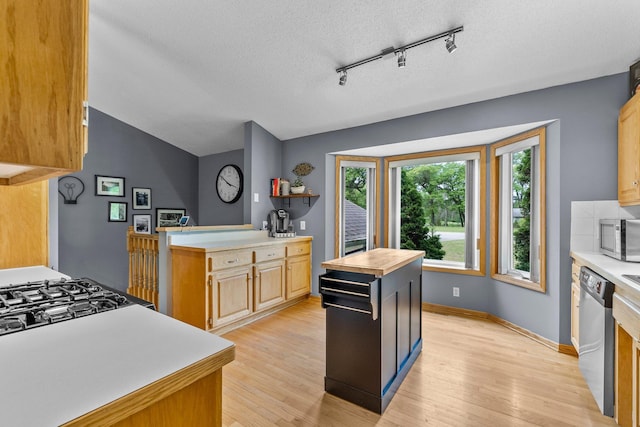 2308 Crosstown Blvd NE, Ham Lake, MN 55304 - kitchen with appliances with stainless steel finishes, light wood-style floors, vaulted ceiling, butcher block counters, and a textured ceiling