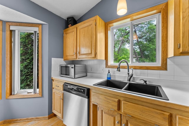 2308 Crosstown Blvd NE, Ham Lake, MN 55304 - kitchen featuring stainless steel appliances, a sink, light countertops, decorative backsplash, and a textured ceiling