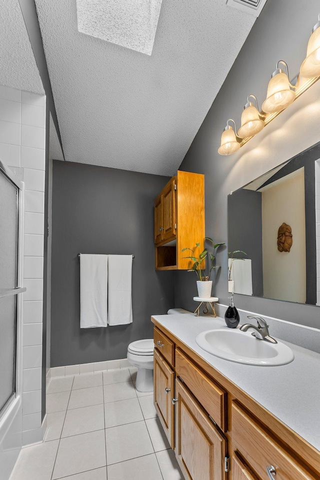 2308 Crosstown Blvd NE, Ham Lake, MN 55304 - full bathroom with a textured ceiling, tile patterned flooring, an enclosed shower, toilet, and vanity
