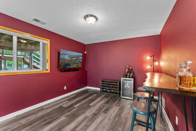 2308 Crosstown Blvd NE, Ham Lake, MN 55304 - office space featuring wood finished floors, a textured ceiling, beverage cooler, and baseboards