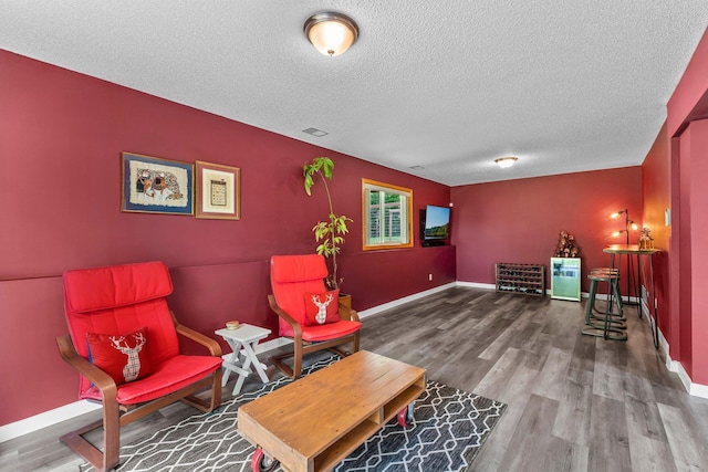 2308 Crosstown Blvd NE, Ham Lake, MN 55304 - living area with a textured ceiling, wood finished floors, and baseboards