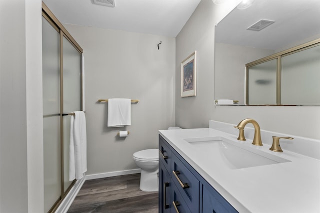 2308 Crosstown Blvd NE, Ham Lake, MN 55304 - bathroom featuring a stall shower, wood finished floors, vanity, toilet, and baseboards
