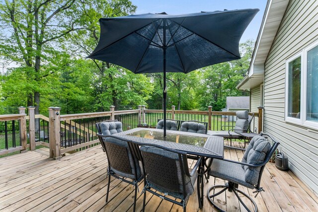 2308 Crosstown Blvd NE, Ham Lake, MN 55304 - deck with outdoor dining space and view of wooded area