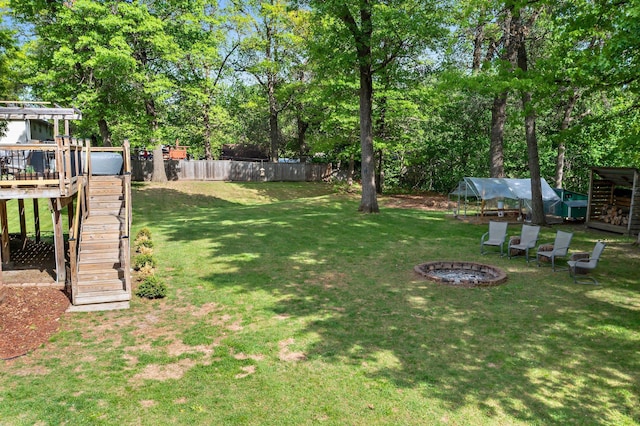 2308 Crosstown Blvd NE, Ham Lake, MN 55304 - view of yard with stairs, a deck, a fire pit, and view of wooded area