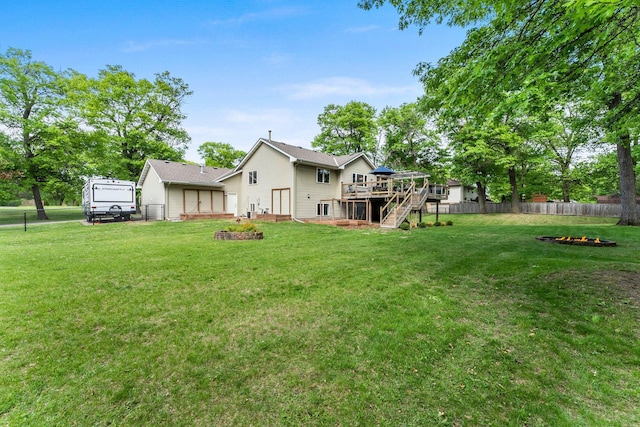 2308 Crosstown Blvd NE, Ham Lake, MN 55304 - back of property featuring a deck, an outdoor fire pit, and stairway
