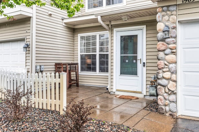 1963 Bluestem Ln, Shoreview, MN 55126 - property entrance with stone siding and a garage