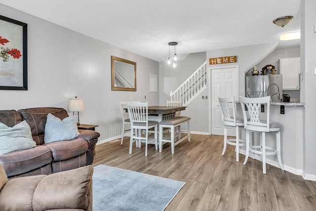 1963 Bluestem Ln, Shoreview, MN 55126 - living area featuring stairway, light wood-style floors, and baseboards