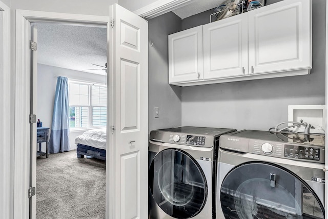 1963 Bluestem Ln, Shoreview, MN 55126 - washroom featuring cabinet space, carpet flooring, washing machine and clothes dryer, and a textured ceiling