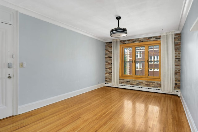 1820 1st Ave S Unit 201, Minneapolis, MN 55403 - empty room featuring light wood-style floors, baseboard heating, baseboards, and crown molding