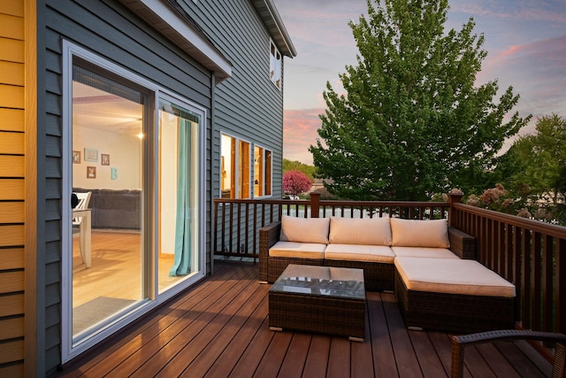 deck at dusk with an outdoor hangout area