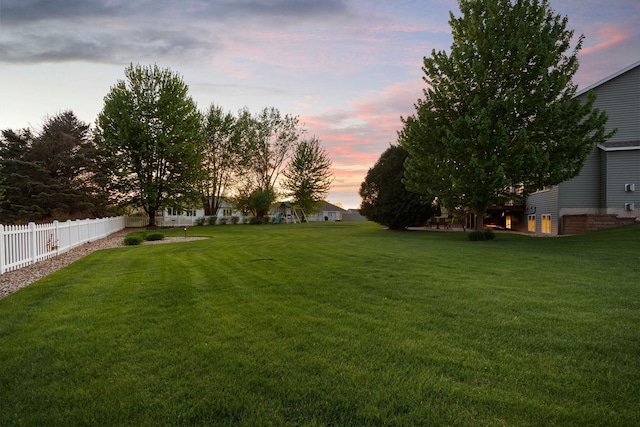 view of yard at dusk