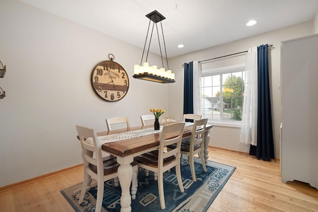 dining space with light wood-type flooring, baseboards, and recessed lighting