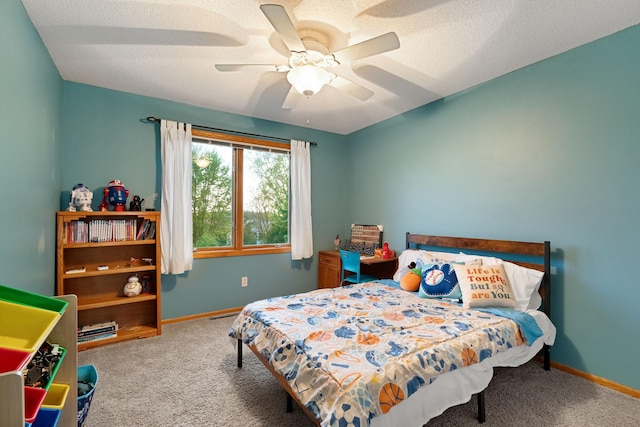 carpeted bedroom featuring baseboards and a ceiling fan