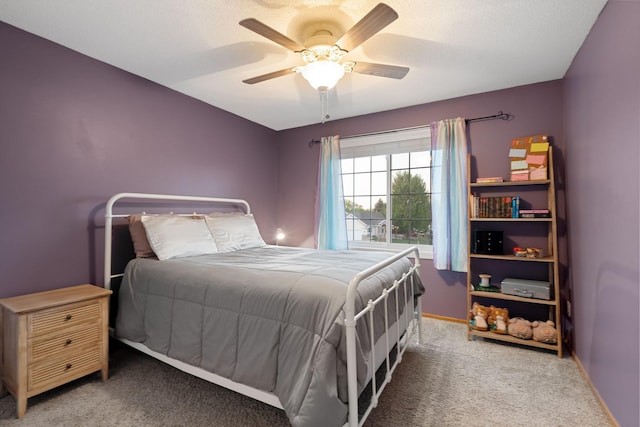 carpeted bedroom featuring baseboards and ceiling fan