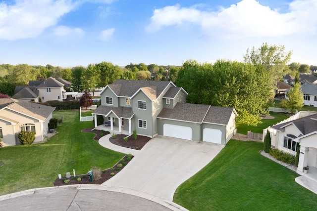 traditional-style house with a residential view, concrete driveway, a front lawn, and a garage