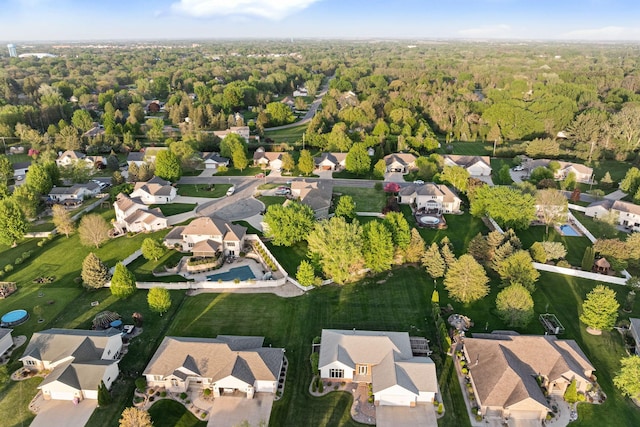 aerial overview of property's location with nearby suburban area and a heavily wooded area