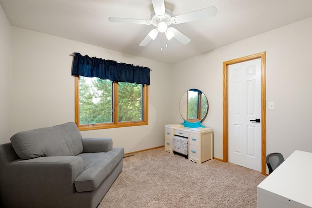 2703 10th Ave SW, Austin, MN 55912 - living area featuring light carpet, baseboards, and ceiling fan
