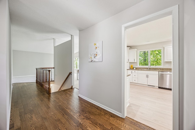 1588 Chatham Ave, Arden Hills, MN 55112 - corridor featuring an upstairs landing, wood finished floors, baseboards, and a sink